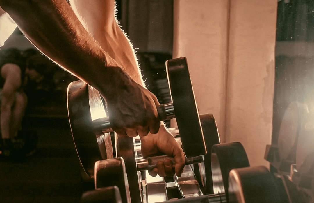 lifting dumbbells from a weight rack